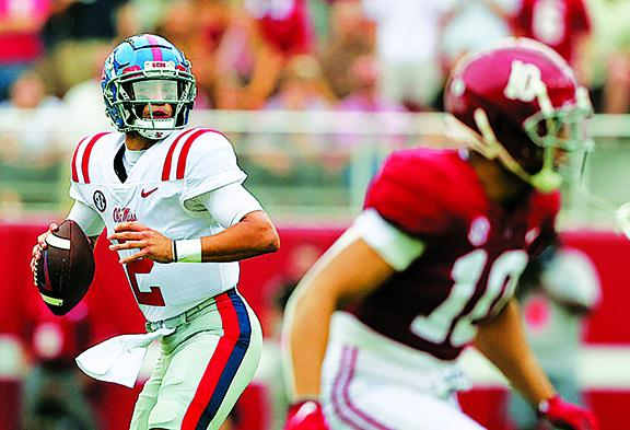 Mississippi Rebels quarterback Matt Corral (2) rolls out to pass against the Alabama Crimson Tide during the first half of an NCAA college football game at Bryant-Denny Stadium.